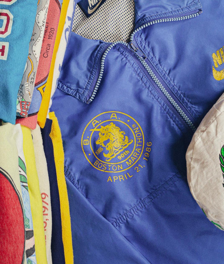 Close-up of vintage Boston Marathon 1986 Nike jacket and retro race shirts.