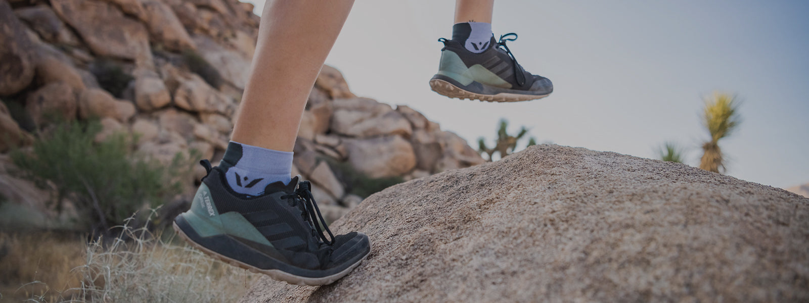 Swiftwick VIBE Socks header image, person trail running wearing VIBE One socks