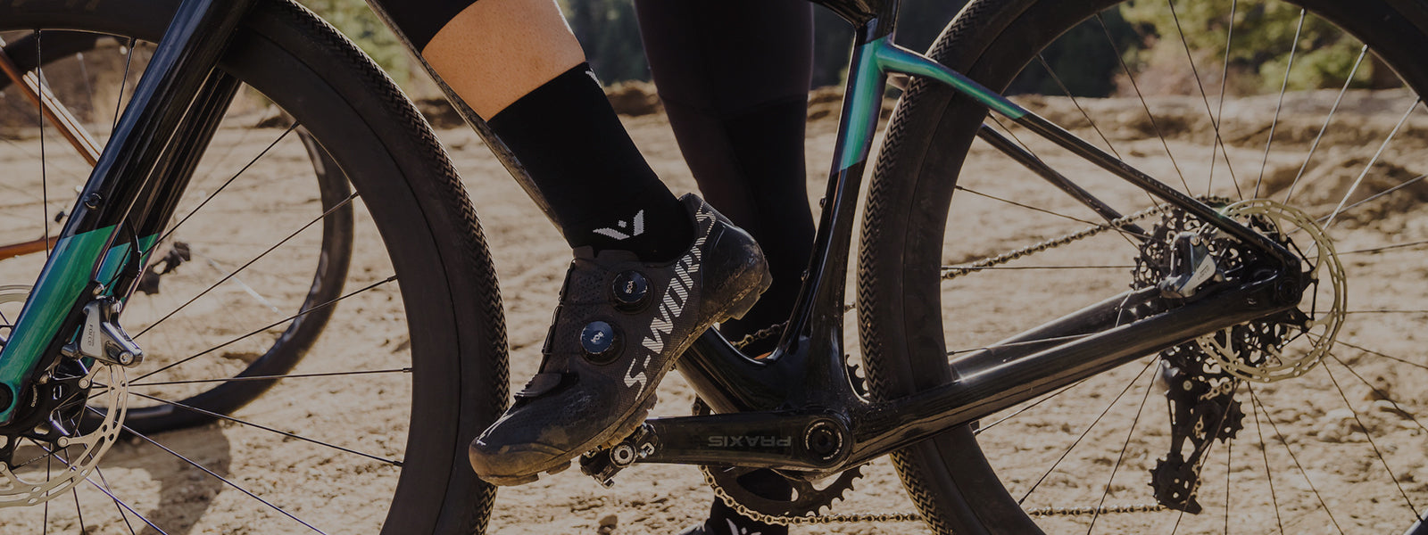 Person riding a bicycle wearing ASPIRE Four socks