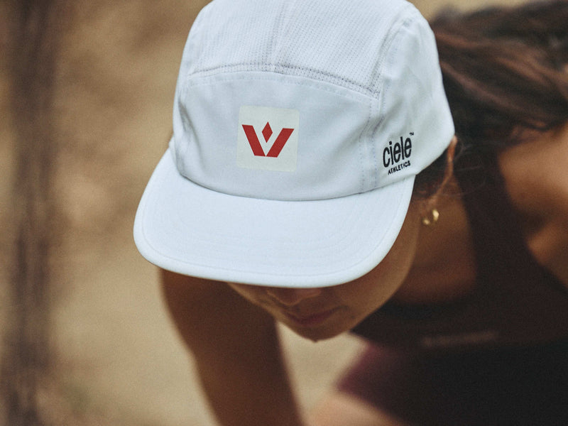 closeup of trail runner wearing a swiftwick hat outdoors