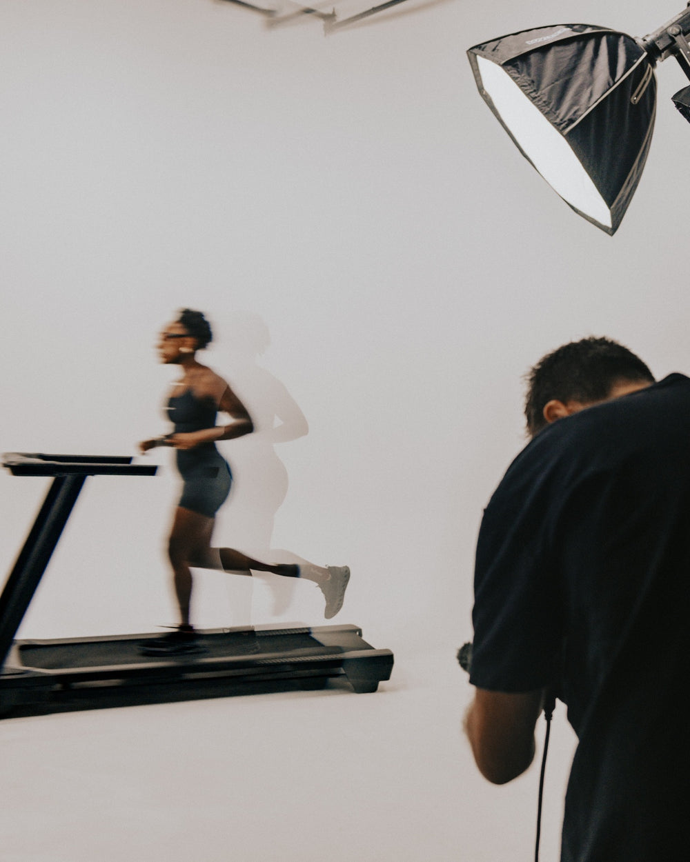 Behind the scenes photo of a Swiftwick Fall 2026 photo shoot in a studio