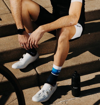 Closeup of cyclist sitting down on pagement.