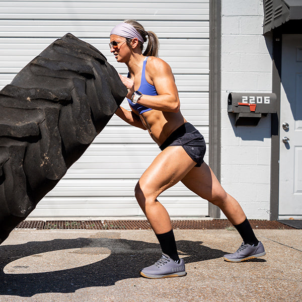 Woman lifting large tire