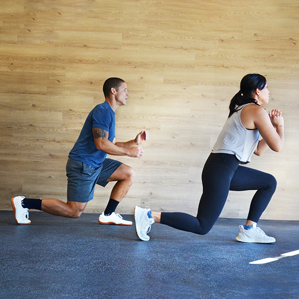 Man and woman working out, wearing Swiftwick socks