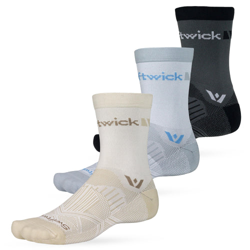 Three Swiftwick performance crew socks in beige, light gray, and dark gray, staggered front to back