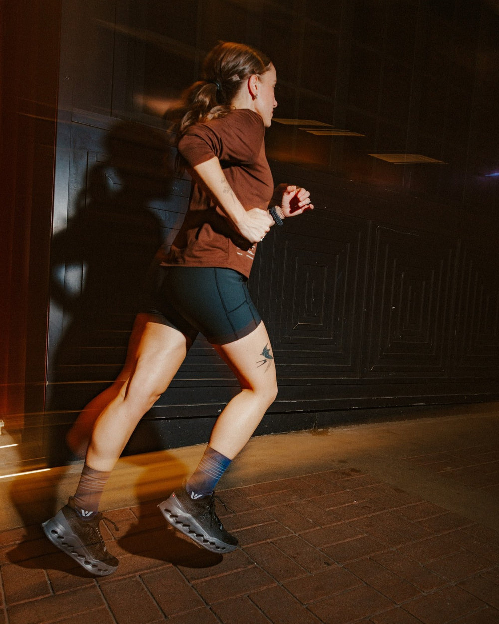 Two runners at night in an urban setting wearing navy Aspire Mid-Crew socks