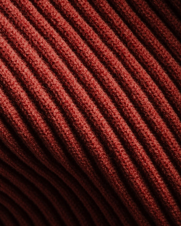 Closeup of red knit sock textile weave